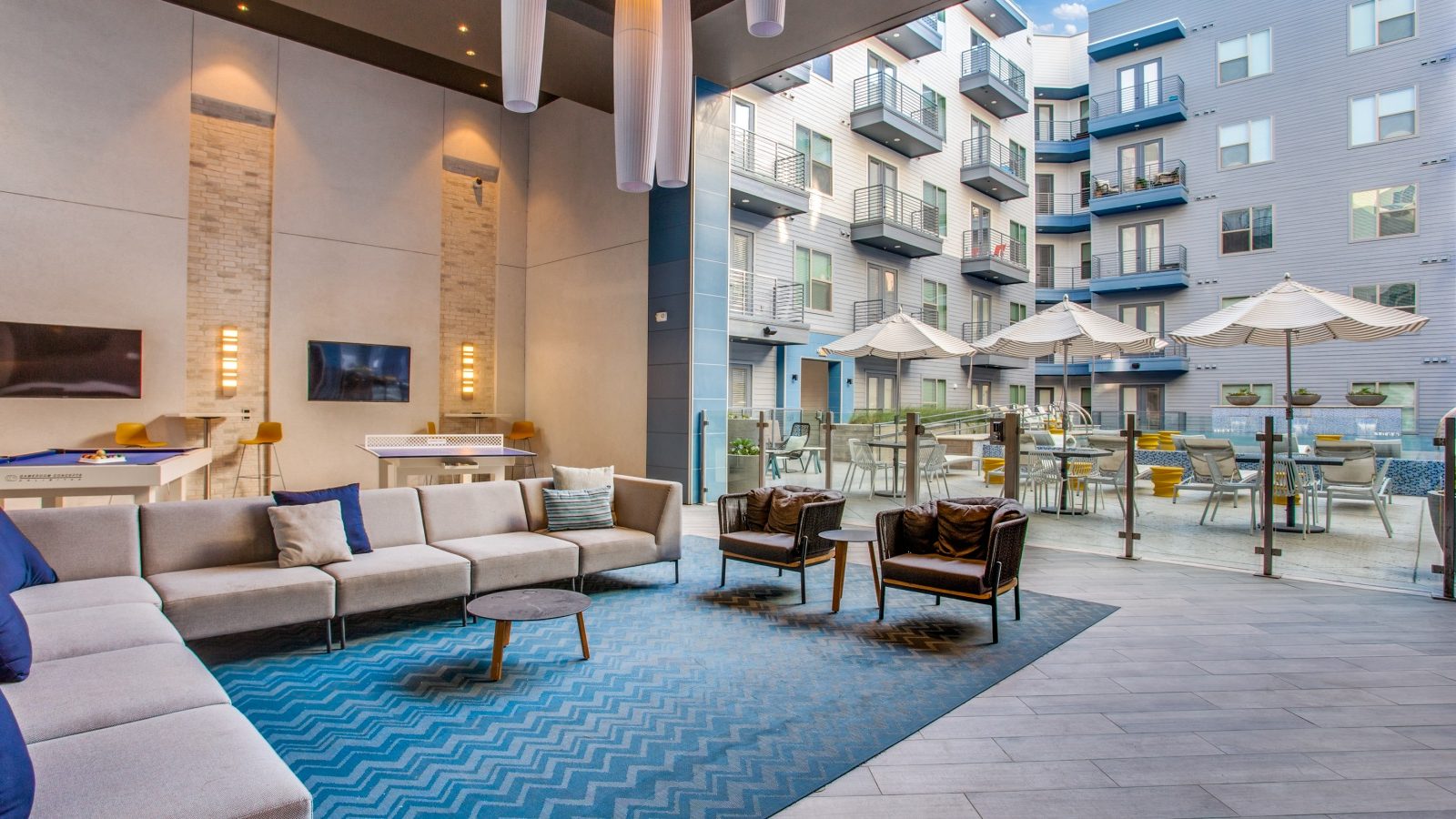 the lobby of an apartment building with blue carpeting at The Ramble and Rose